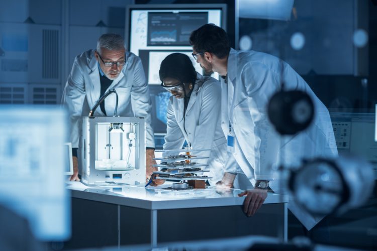 Diverse group of scientist collaborating on research/a project in a lab