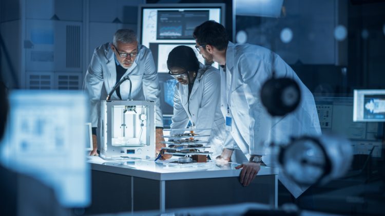 Diverse group of scientist collaborating on research/a project in a lab