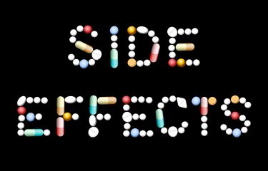 Various shapes and colours of pills and capsules spelling out the words 'side effects' - idea of adverse events related to taking drugs