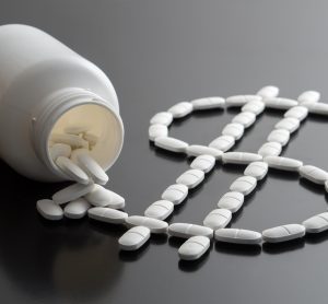 medicine bottle spilling white pills in the shape of a dollar sign - idea of pharma finances or drug pricing