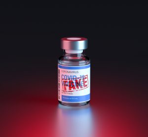 Vial labelled 'COVID-19 Vaccine' with red stamp proclaiming 'FAKE' over label - idea of counterfeit vaccines