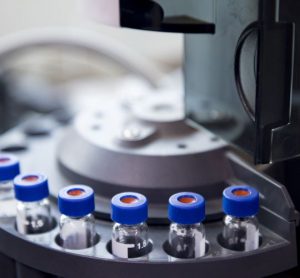 blue capped vials are arranged in the auto-sampler of gas chromatography equipment