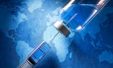 Vaccine and syringe with world map background