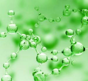 Transparent green abstract molecule model over blurred green molecule background.
