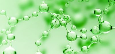 Transparent green abstract molecule model over blurred green molecule background.