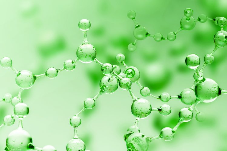 Transparent green abstract molecule model over blurred green molecule background.