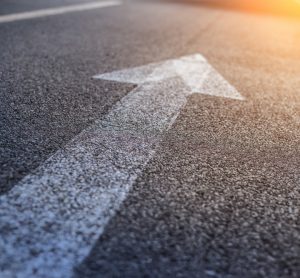 painted white arrow on tarmac road surface - idea of guidance