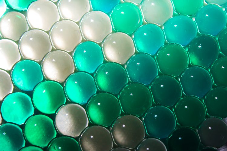 blue and green hydrogel balls in rows