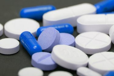pile of blue and white pills