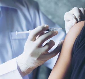 doctor injecting patient using syringe