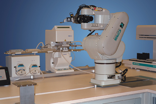 Figure 5: CRS robotic arm (Thermo Scientific) integrated in an assay system with peripheral devices capable of performing fully automated biological assays.