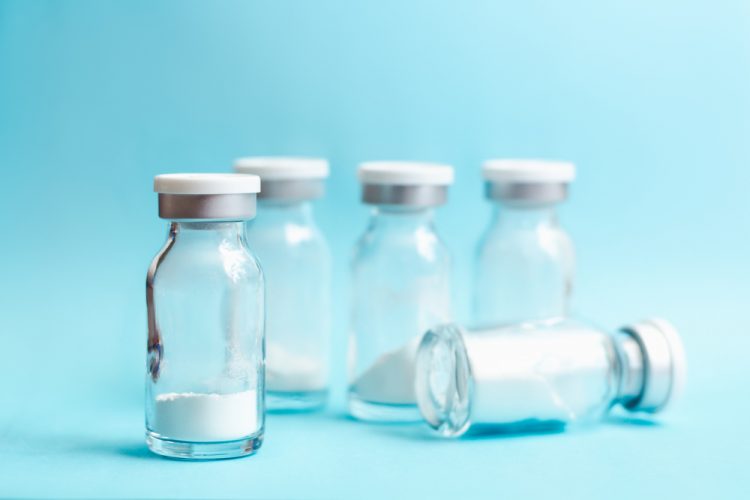 lyophilised drug cake in glass vials - white powder in glass vaccine vials