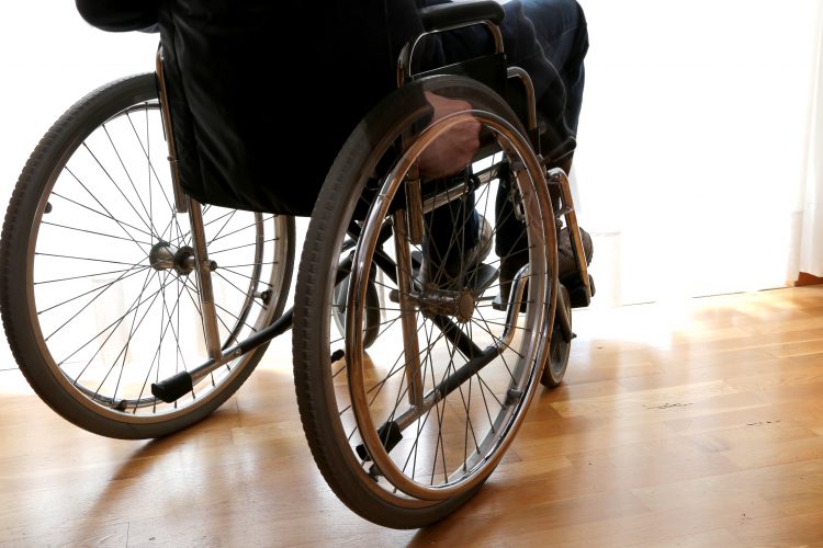 disabled person, potentially suffering with ALS, in a wheelchair