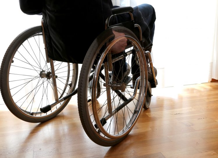 disabled person, potentially suffering with ALS, in a wheelchair