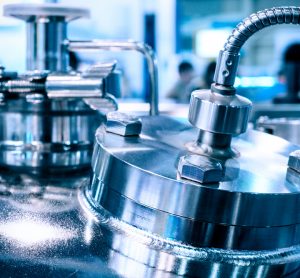 Close up of the steel case of a chemical reactor, selective focus