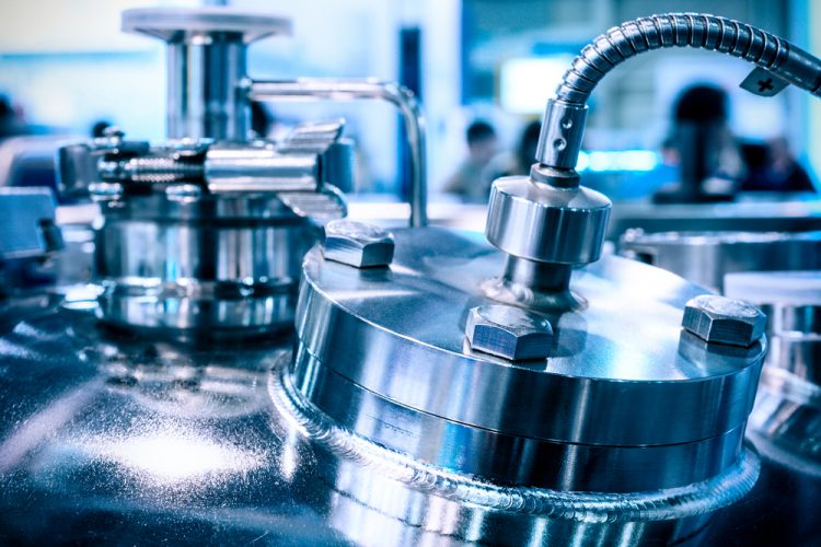 Close up of the steel case of a chemical reactor, selective focus