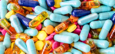 various colourful capsules in a pile filling the whole image - idea of supply of medicines