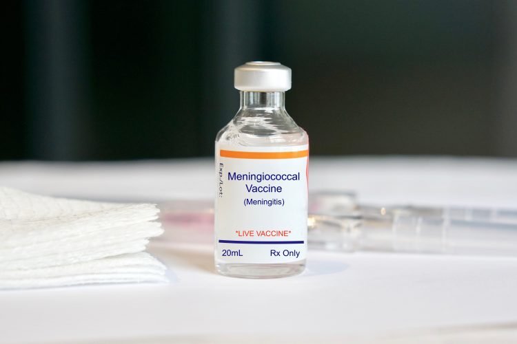 vial labelled 'Meningococcal vaccine' next to syringe and gauze pads