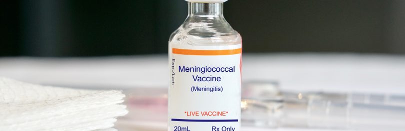 vial labelled 'Meningococcal vaccine' next to syringe and gauze pads