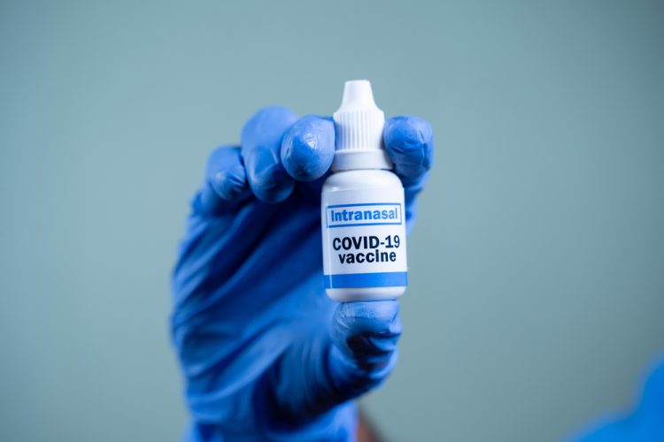 nasal vaccination concept - nasal spray labelled intranasal COVID-19 Vaccine