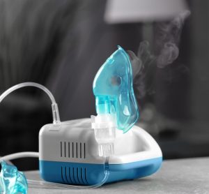 Compressor nebulizer with mask on table