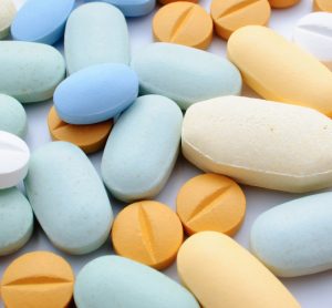 Pile of colourful pharmaceutical tablets in orange and blue