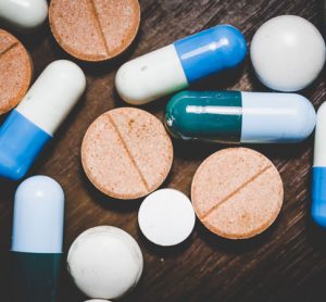 pills and capsules on a wooden background