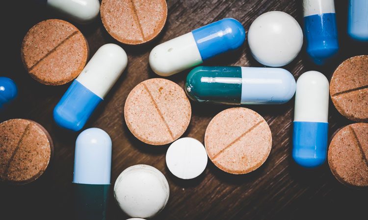 pills and capsules on a wooden background