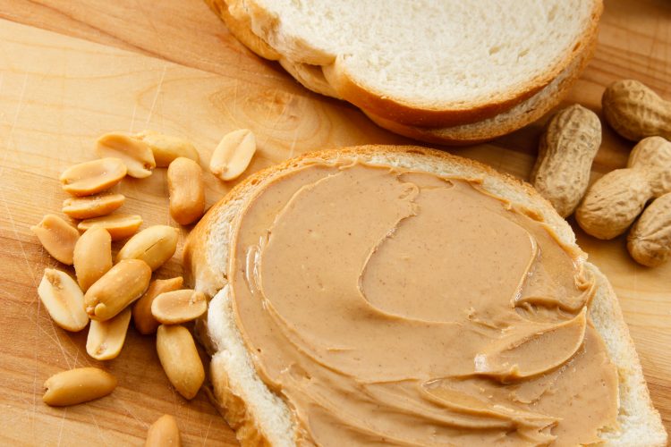 peanuts, peanut butter on bread and monkey nuts laid out as examples of peanut allergens