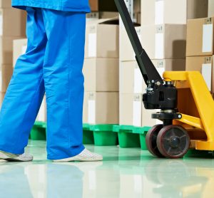 pharmaceutical warehouse worker moving boxes