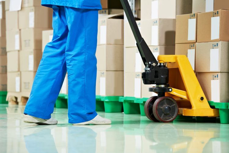 pharmaceutical warehouse worker moving boxes