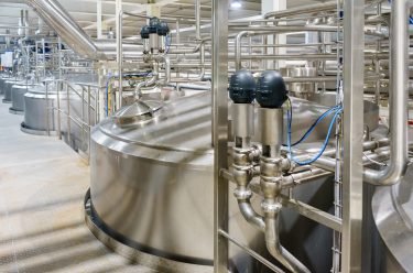 pharmaceutical manufacturing facility with large silver tanks