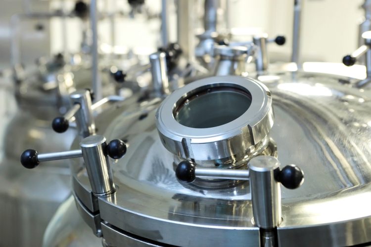 top of a stainless steel reactor within a pharmaceutical manufacturing facility