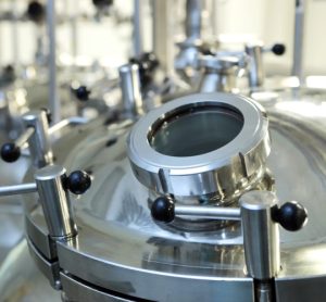 top of a stainless steel reactor within a pharmaceutical manufacturing facility