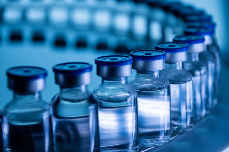 filled glass vials on a production line