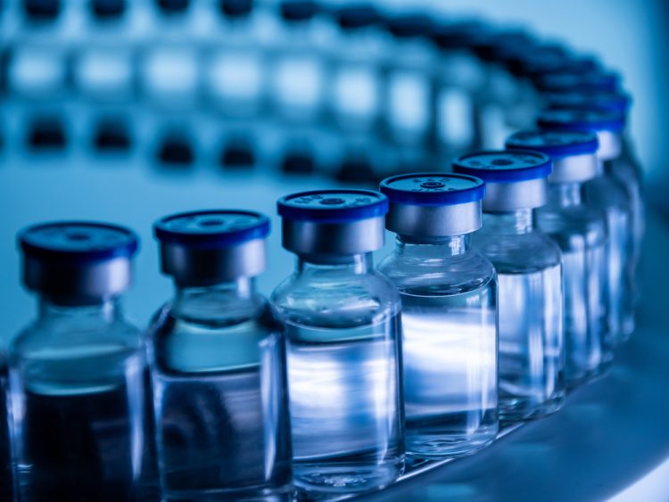 filled glass vials on a production line