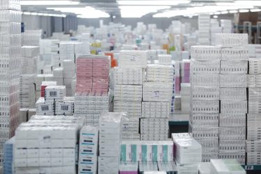 Pharmaceutical warehouse with thousands of boxes of pharmaceuticals and vitamins ready to be distributed - idea of medicines supply [Credit: OVKNHR / Shutterstock.com].