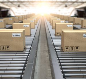 Cardboard boxes on conveyor belts heading out into the distance - idea of pharma supply chains