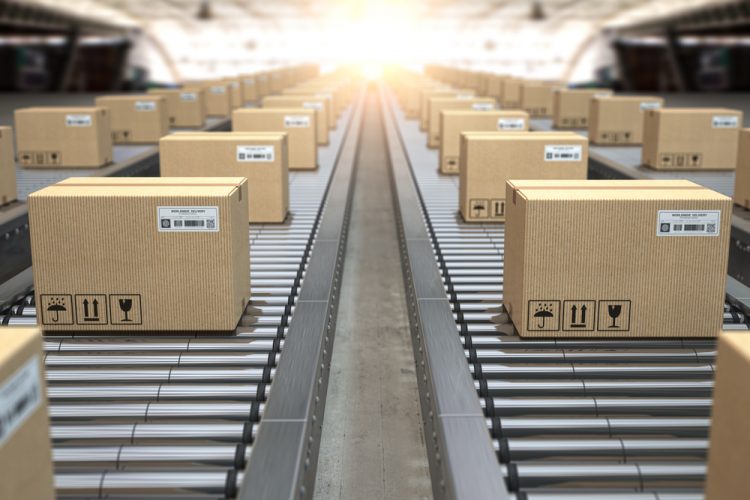 Cardboard boxes on conveyor belts heading out into the distance - idea of pharma supply chains