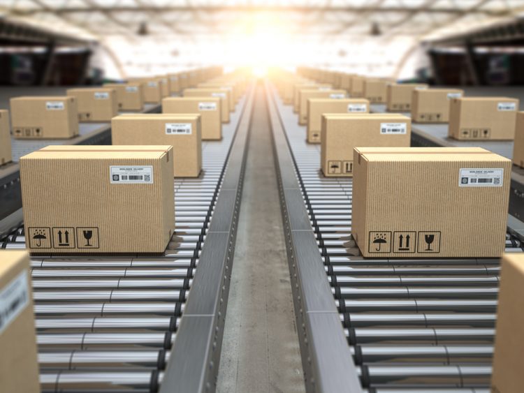 Cardboard boxes on conveyor belts heading out into the distance - idea of pharma supply chains