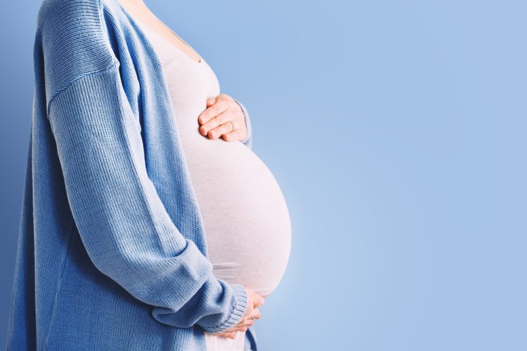 Woman holding pregnant stomach