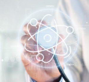 concept of radioligand therapy - Doctor holding a stethoscope over an atom icon surrounded by data