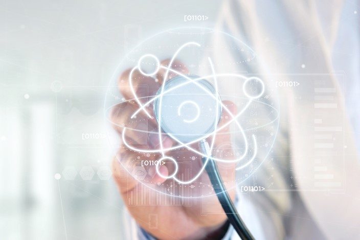 concept of radioligand therapy - Doctor holding a stethoscope over an atom icon surrounded by data