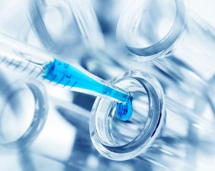 pipette dropping blue liquid into a test tube - idea of biosimilar research