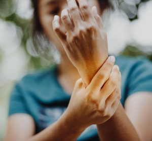 Woman with arthritis holding wrist