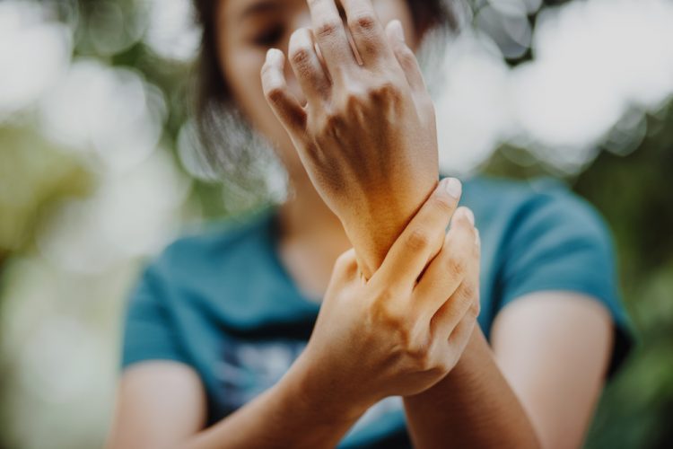 Woman with arthritis holding wrist