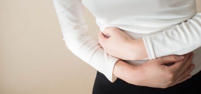 Young woman clenching stomach in pain