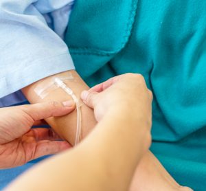 Patient receiving treatment via intravenous infusion