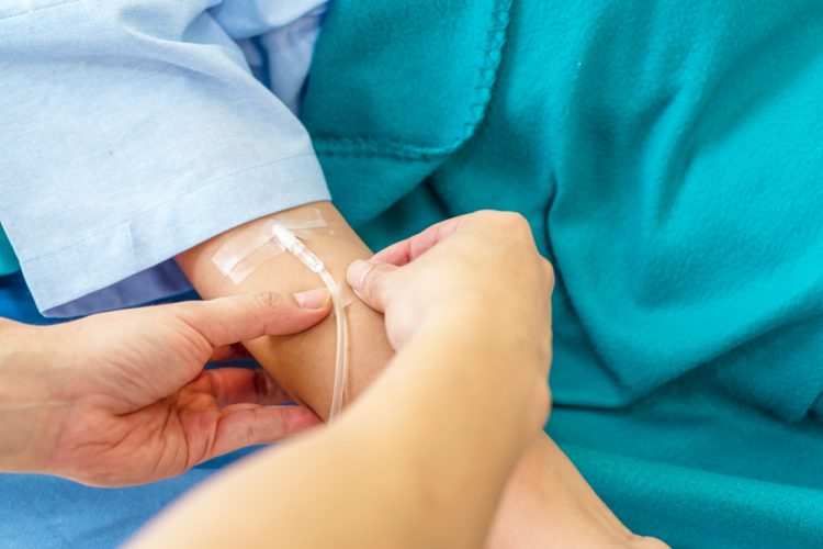 Patient receiving treatment via intravenous infusion