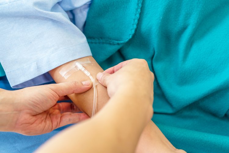 Patient receiving treatment via intravenous infusion